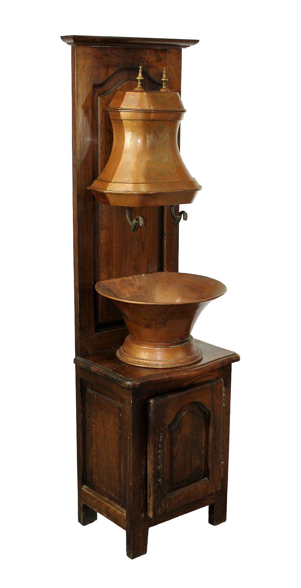 French copper lavabo mounted on oak cabinet: French copper lavabo mounted on oak cabinet. Early 20t century. 67 1/2"h x 19 1/2"w x 14"d