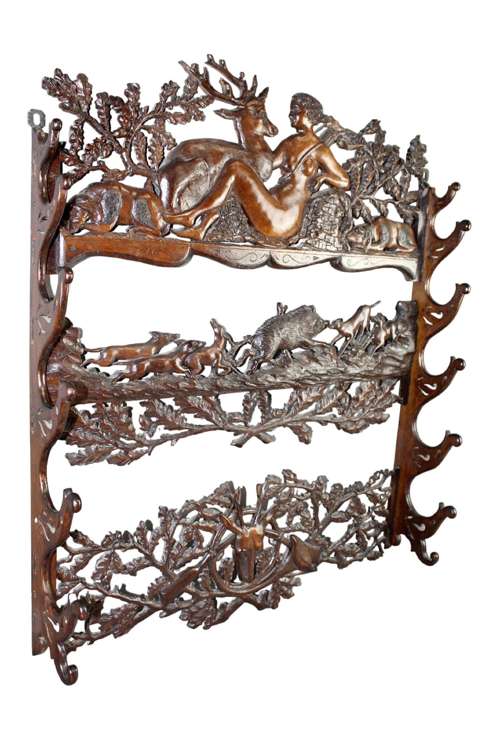 Black Forest carved wall mount gun rack with Diana the huntress: Black Forest carved wall mount gun rack with Diana the huntress, deer head, wild boar and hunting dogs. 19th century. 31 1/2" h x 26 3/4" w x 4 3/4" d