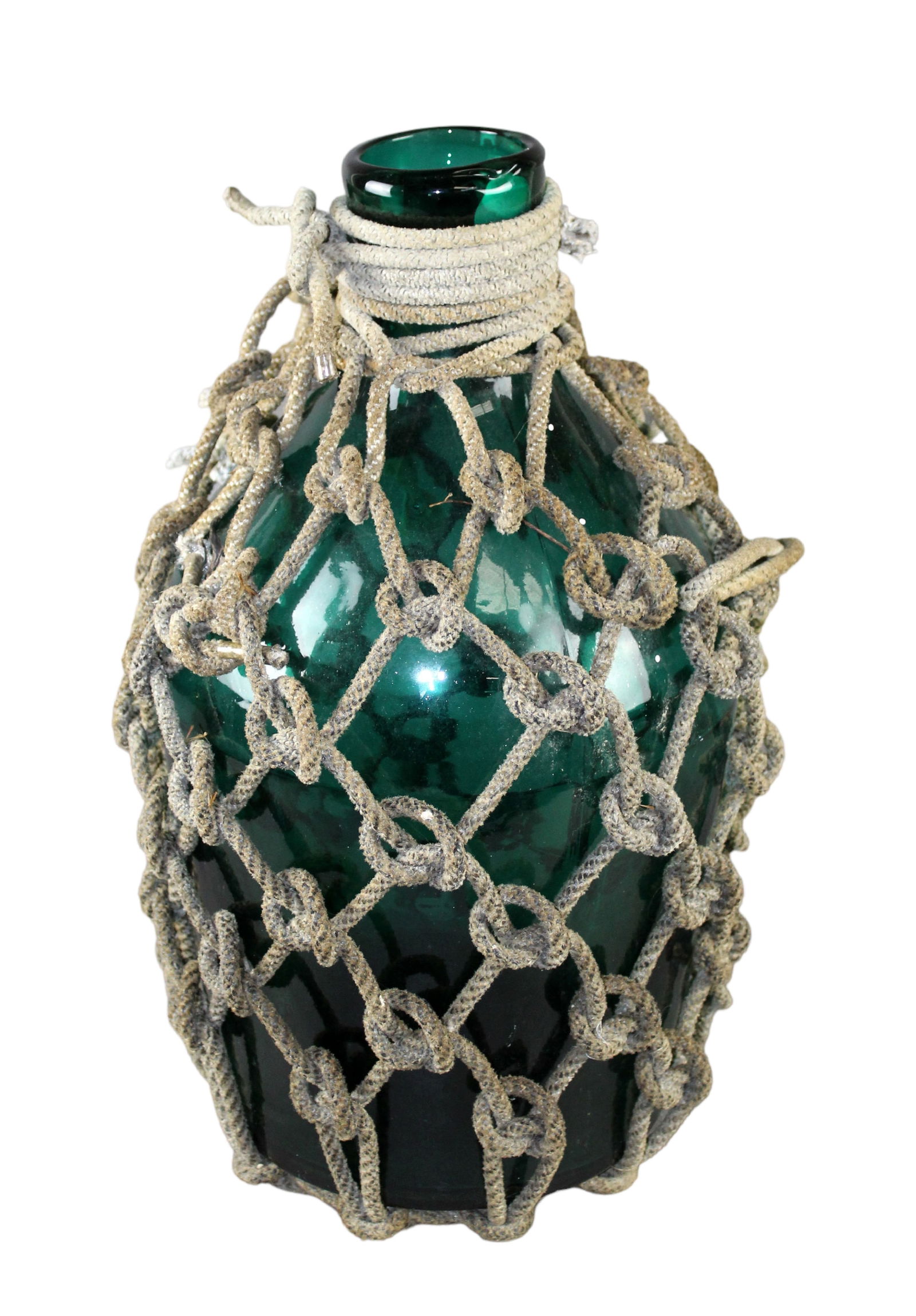 Antique green glass rum cask in rope: Antique green glass rum cask in rope 17 3/4" h x 10" diam (approx)