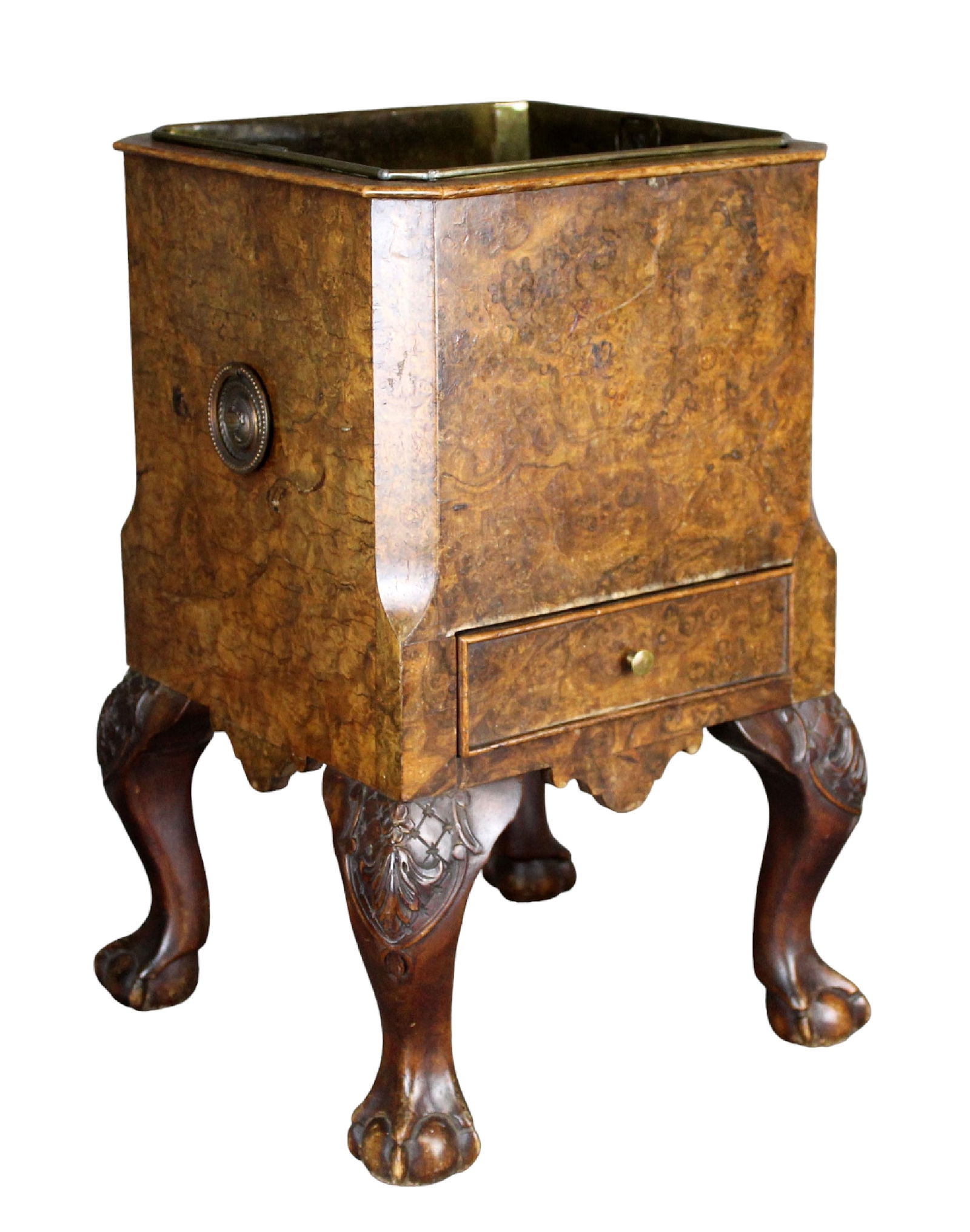 English burled walnut jardiniere on ball & claw feet: English burled walnut jardiniere on ball & claw feet. Ring handles on sides, single drawer. Removable brass liner. Early 20th century. 18 3/8"h x 10 1/2" square (11 3/4" square at base)
