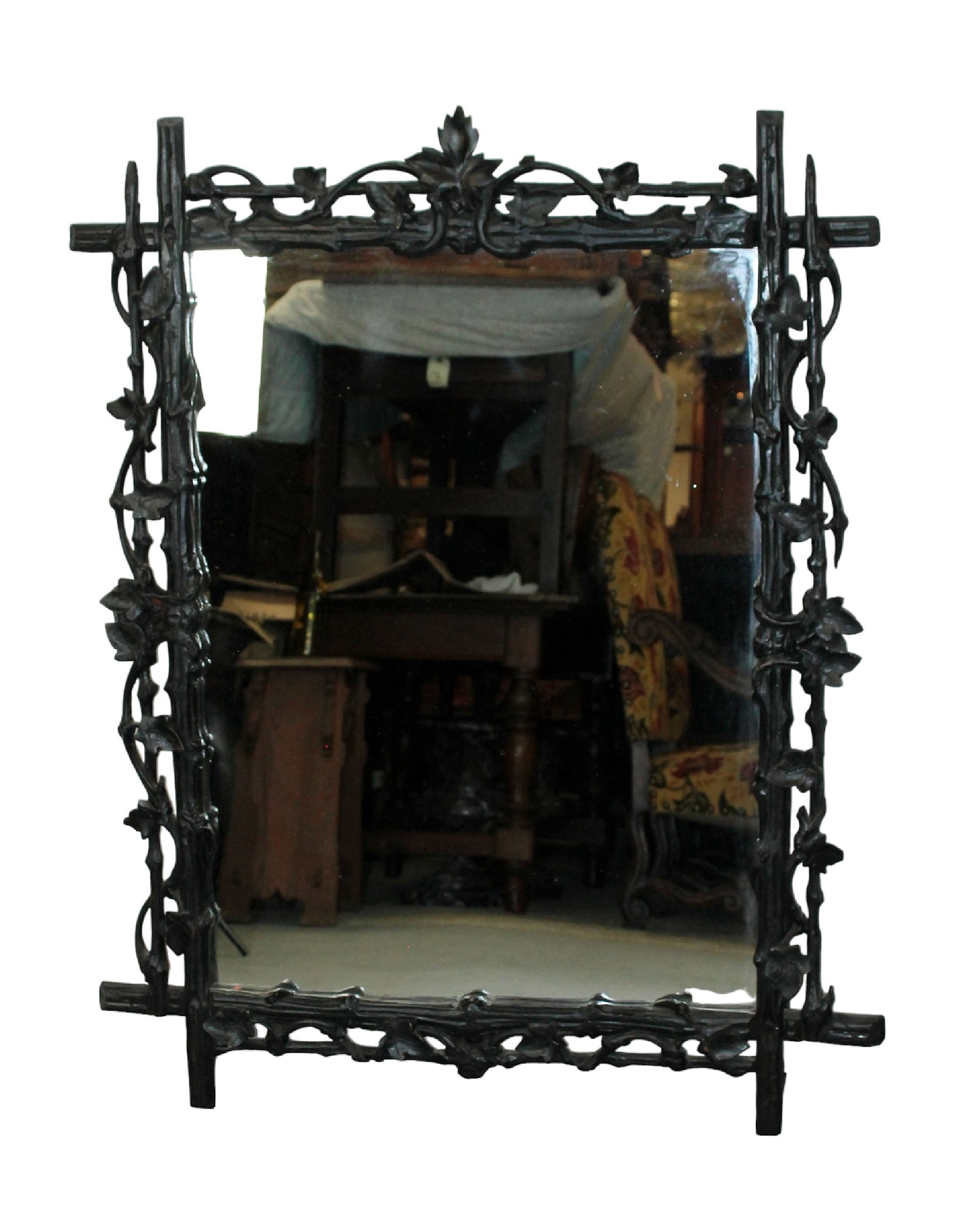 Carved and ebonized Black Forest mirror with trailing grapevines on tree branches: Carved and ebonized Black Forest mirror with trailing grapevines on tree branches. Late 19th century. 45"h x 36"w