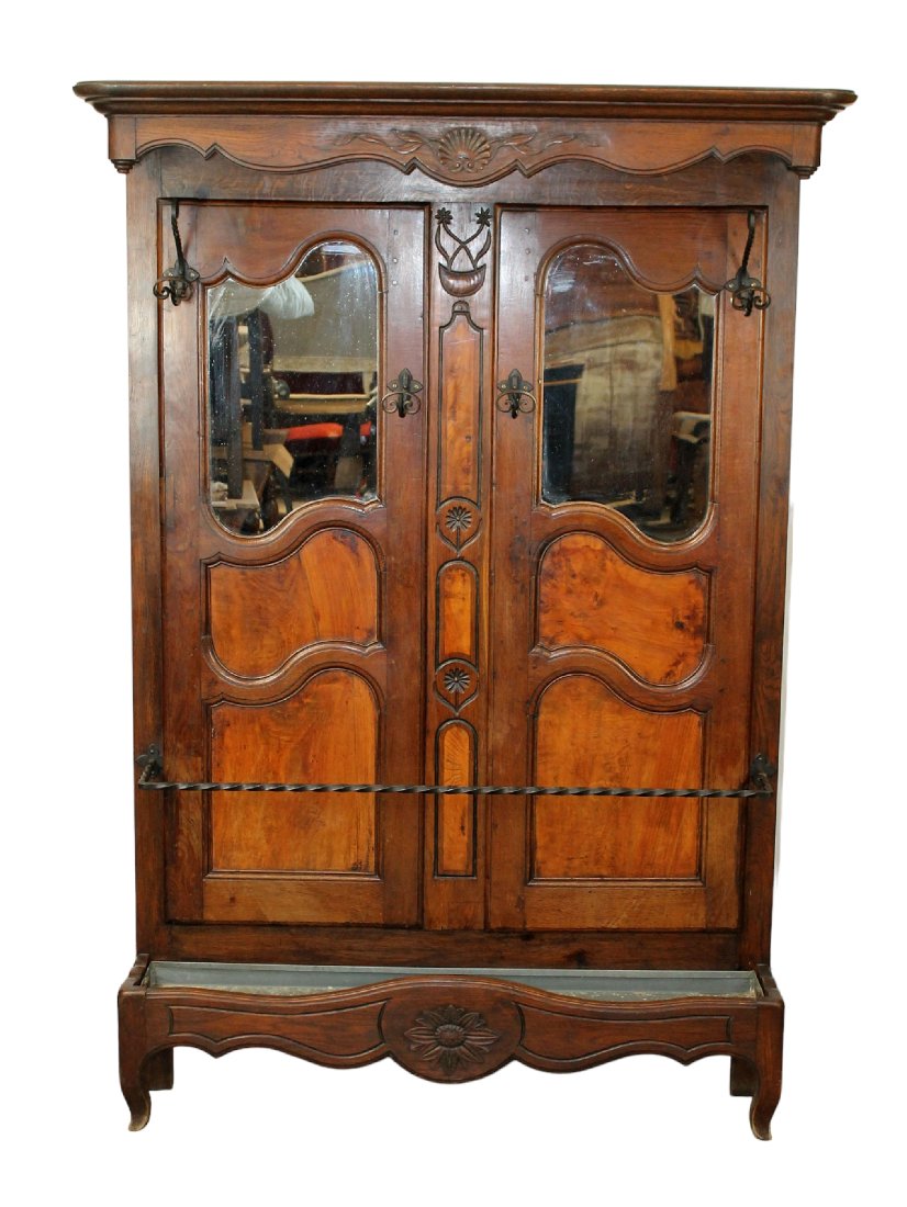 French Provincial halltree in walnut and burl walnut: French Provincial halltree in walnut and burl walnut with iron hooks. Early 20th century. 77 1/2"h x 54 1/2"w x 12"d