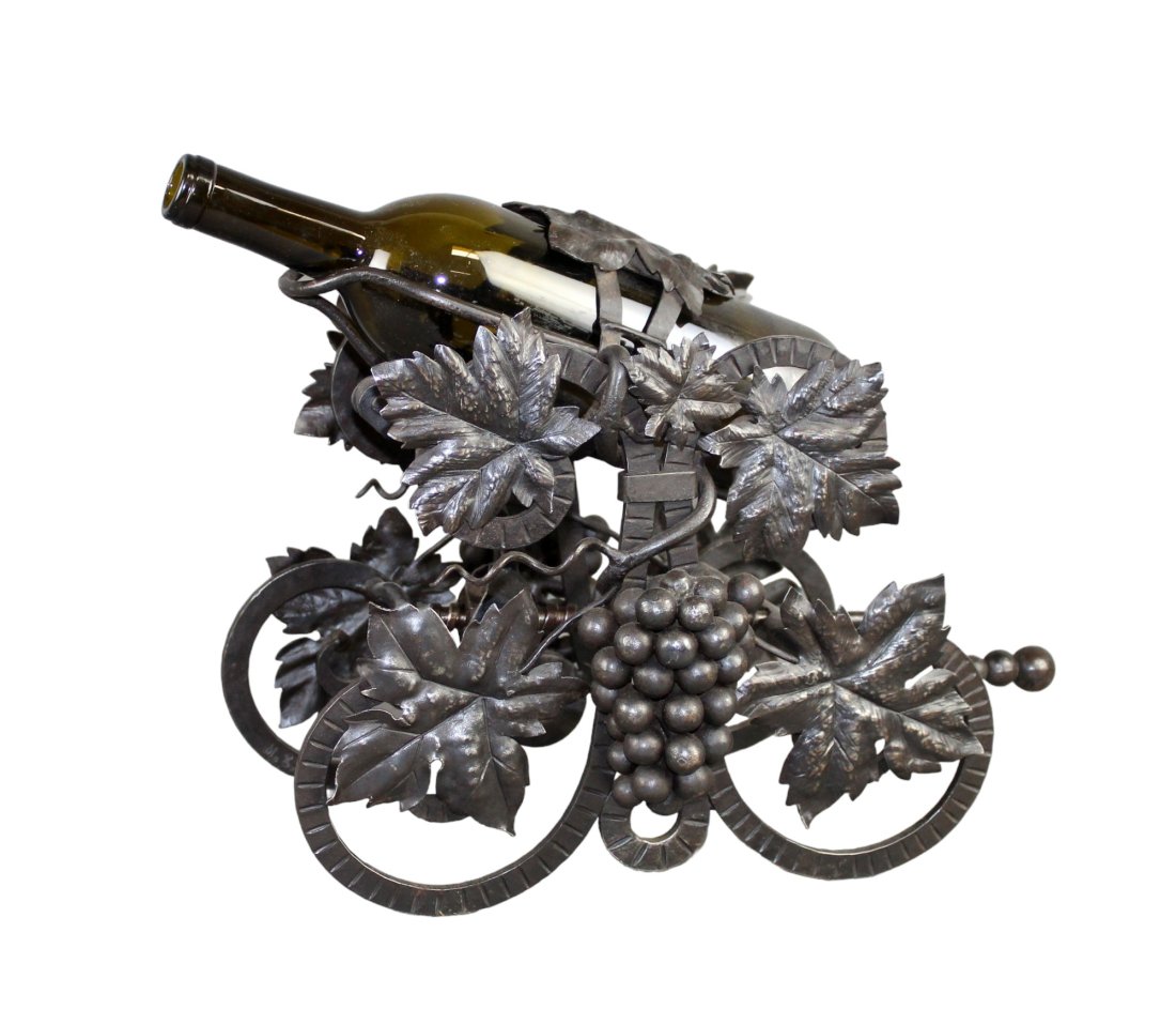 French wrought iron mechanical wine pourer with grape vines: French wrought iron mechanical wine pourer. Decorated with grape vines and signed M. Zaugg. Approx 10 1/2"h x 13"l x 9 1/4"w