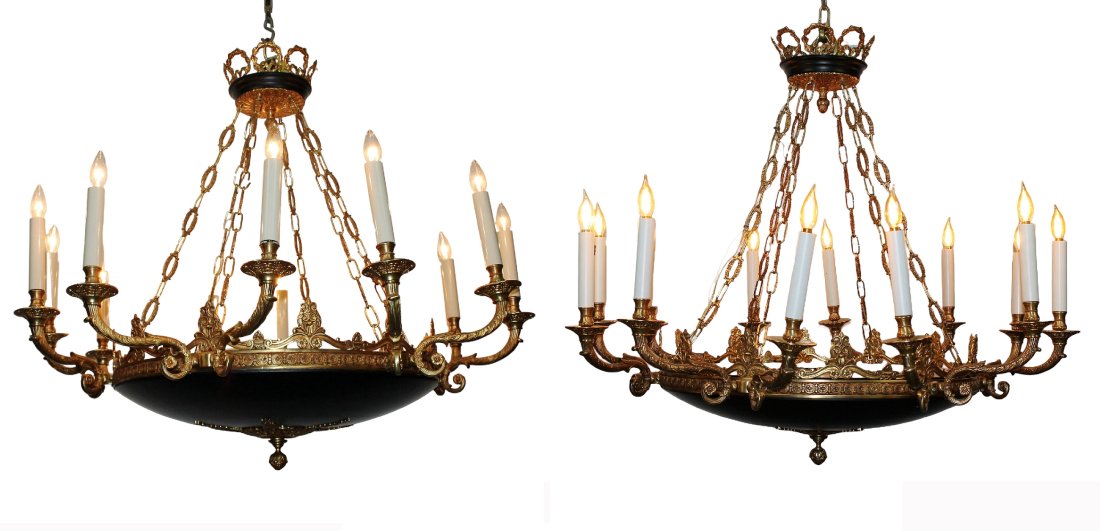 Pair Empire style bronze & black tole 12-arm chandeliers: Pair Empire style 12-arm bronze & black tole chandeliers. Late 20th century. 44 1/2" dia x 38 1/2" drop