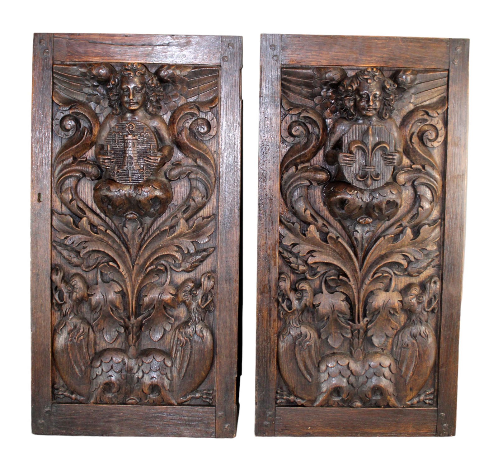 Pair of French relief carved panels with cherubs holding crests (1 of 10)