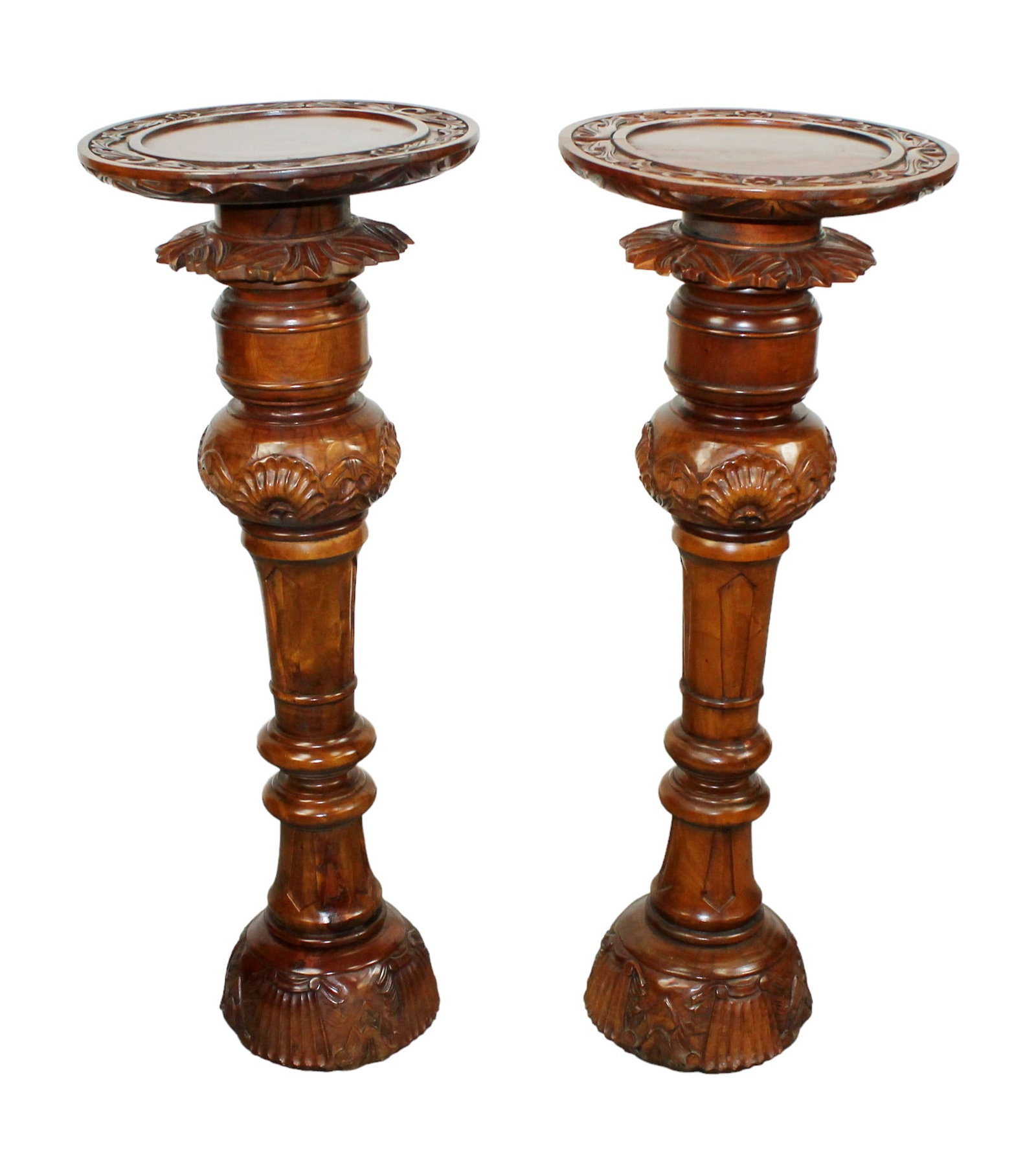 Pair of carved mahogany pedestals: Pair of carved mahogany pedestals. Late 20th century. 39 3/8"h x 15" dia top.