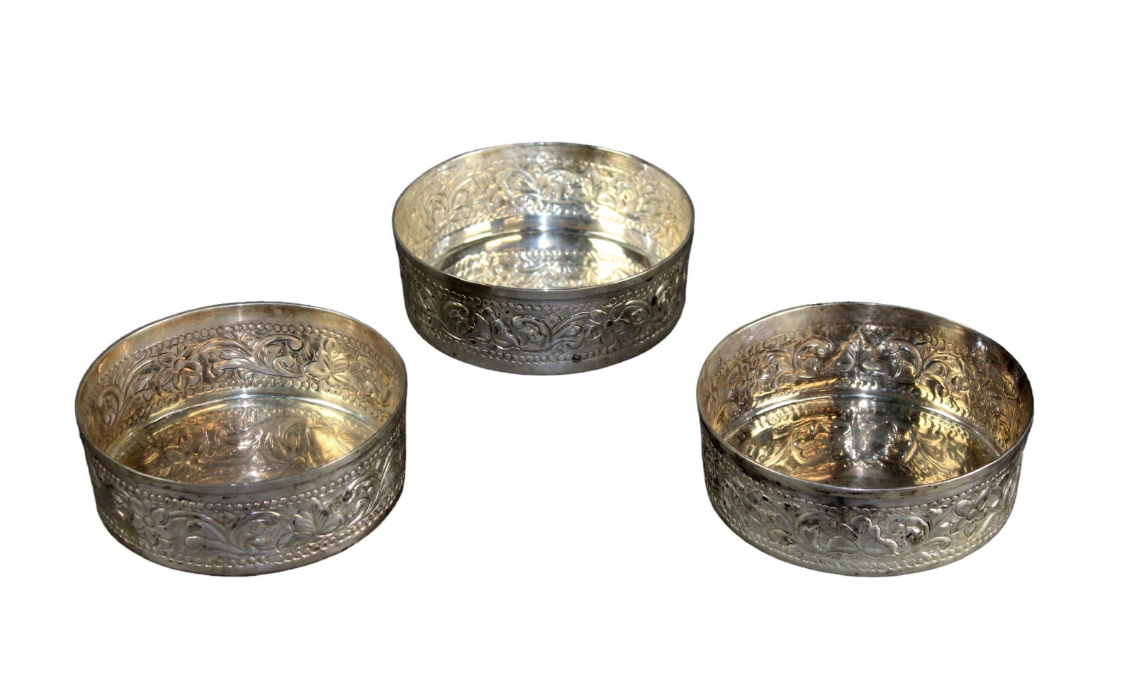 Lot of 3 French silver plated wine bottle coasters: Lot of 3 French silver plated embossed wine bottle coasters. Each measure approx.: 1 3/4"h x 4 3/4"diam. Total weight: 2lbs.