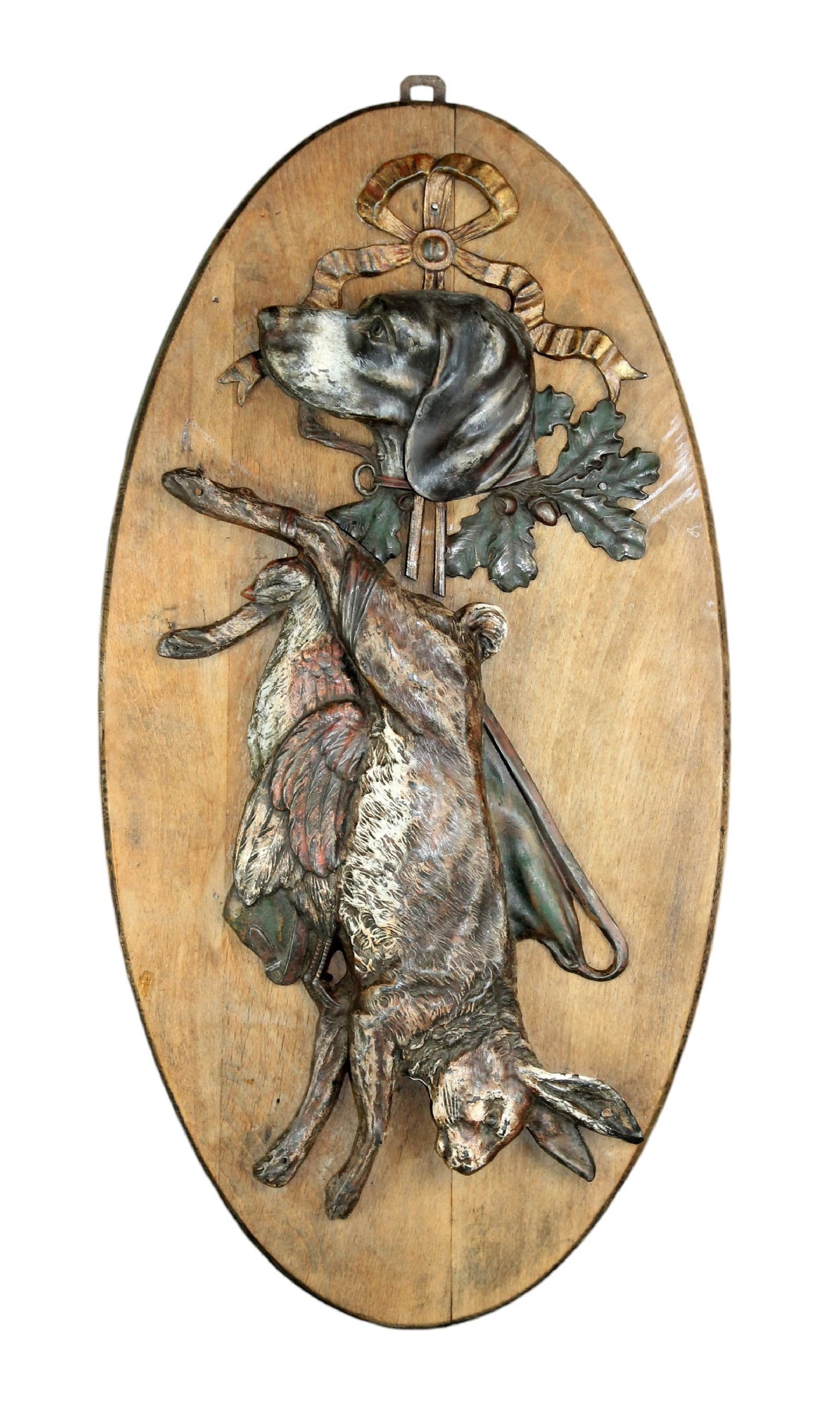 French trophy plaque with rabbit and dog in relief: French trophy plaque with rabbit and dog in relief with a polychrome finish. Mounted on oval wooden plaque. Mid 20th century. 23"h x 11 1/2"w. Weight: 5lbs