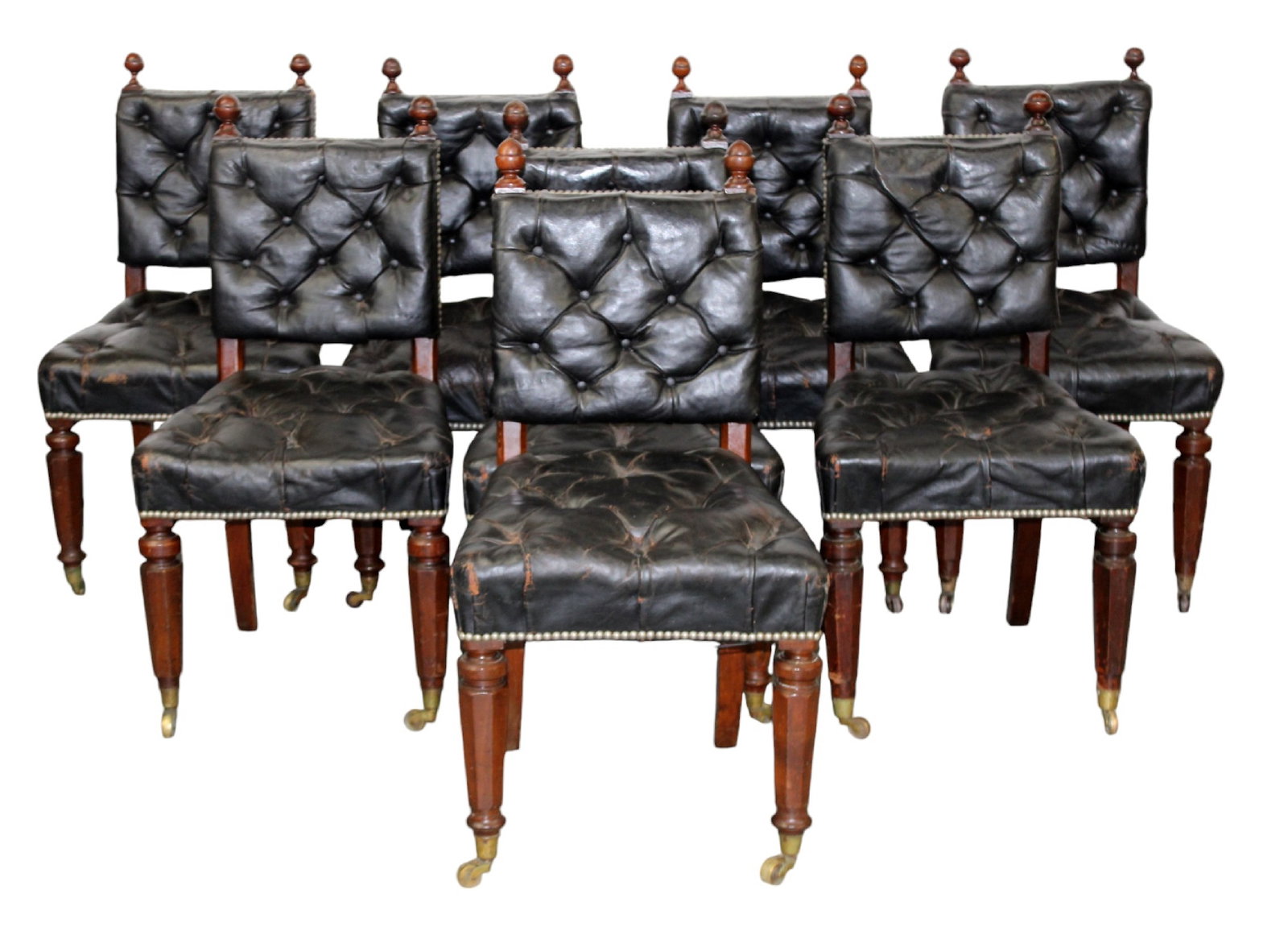 Set of 8 English tufted leather and walnut chairs: Set of 8 English tufted leather and walnut chairs on tapered legs with nail head border detailing. Mid 19th century. 38 1/2"h x 20"w x 19 1/2"d, seat height 19"