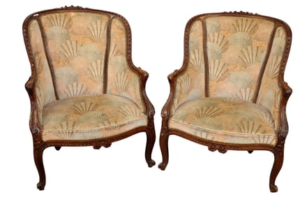 Pair of French Regency carved walnut bergeres
