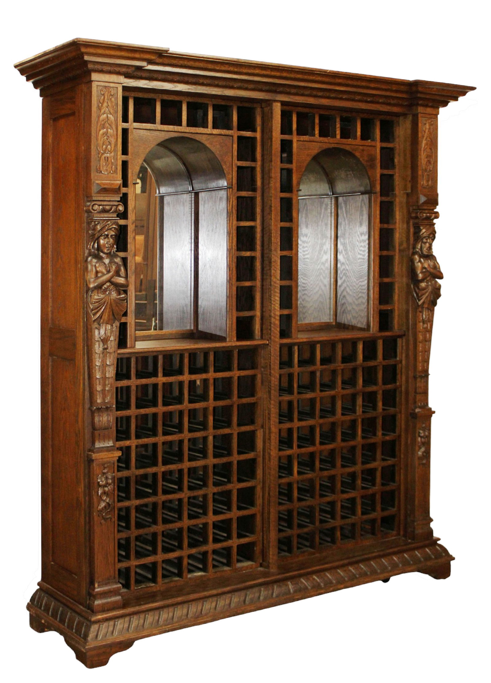 American back bar wine storage cabinet in oak with figural mounts: American back bar wine storage cabinet in oak with figural mounts. 87"h x 77"w x 21"d