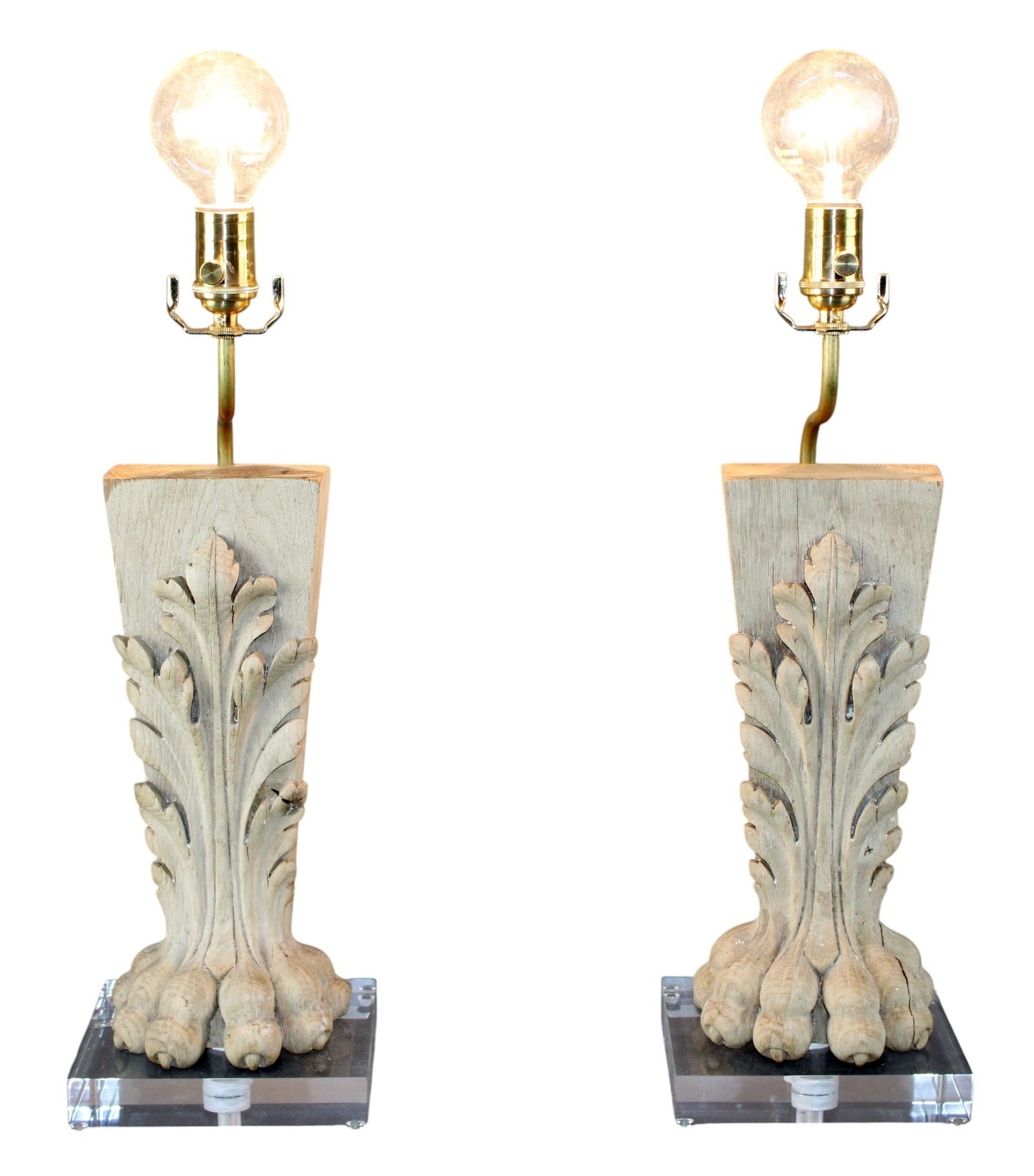 Pair of carved oak paw foot fragment lamps: Pair of carved oak paw foot fragment lamps on lucite bases. 21 3/4"h (without bulb) x 7"w x 6"d (each, approx.). Weight: 6lbs (each, approx.).