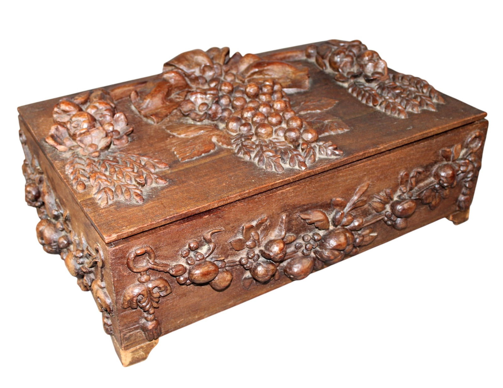 French relief carved walnut trunk with grapevines: French relief carved walnut trunk with grapevines. Early 20th century. 9 5/8"h x 26 3/4"w x 18 1/2"d. Weight: 18lbs.