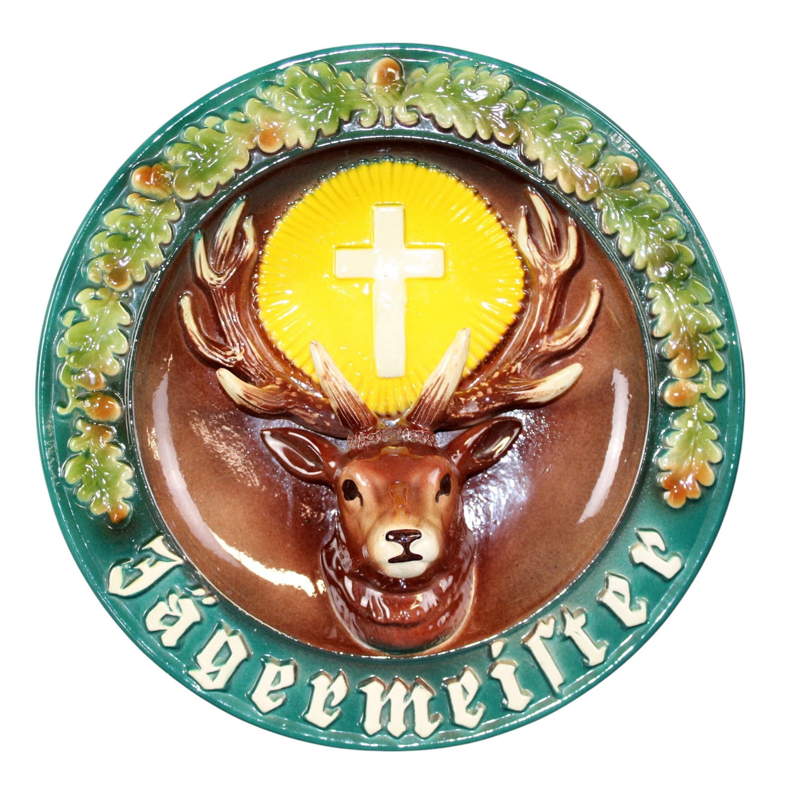 Keramik Ransbach Jagermeister ceramic wall plaque with deer head and cross: Keramik Ransbach Westerwald Jagermeister ceramic wall plaque with deer head and cross. Maker's mark on back. 11 1/4"diam x 4"d. Weight: 3lbs.