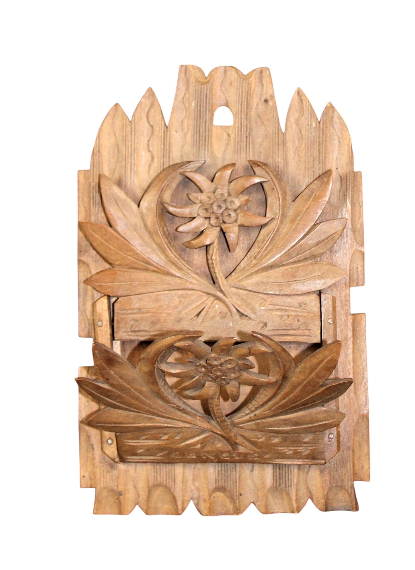 Swiss Black Forest carved linden wall mount letter pocket: Swiss Black Forest wall mount letter pocket in linden wood carved with Edelweiss flower and Geneve. Early 20th century. 8"h x 5"w overall. Weight is less than 1lbs