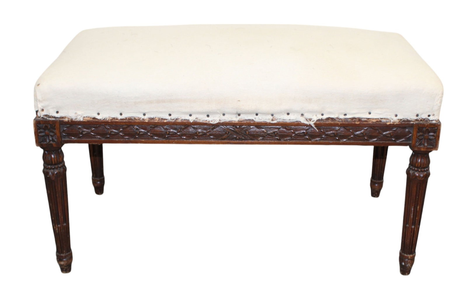 French Louis XVI style bench on tapered legs: French Louis XVI style bench in walnut on fluted legs. Early 20th century. The height at the side is 14" and in the middle is 16"h x 26"w x 14 1/2"d.