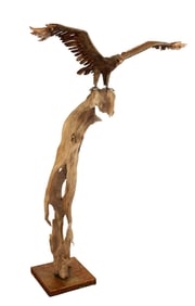 Artisan copper eagle sculpture atop driftwood base