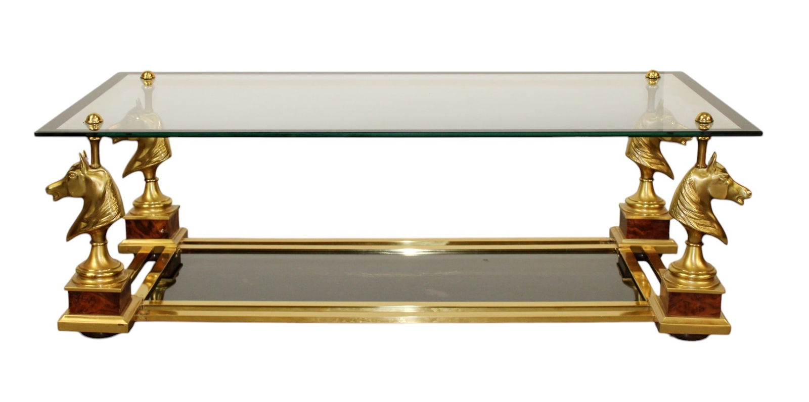 French Maison Charles style horse head coffee table: French Maison Charles style horse head coffee table. 4 brass horse head supporting glass top. Circa 1970's. 15"h x 47"l x 23 1/2"w