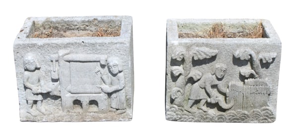 Pair of cut stone square garden planters with figures