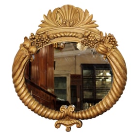 Italian giltwood oval mirror with shell crest flanked by carved fruit