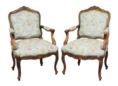 Pair of French Louis XV carved walnut armchairs