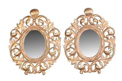 Pair of oval bronze framed mirrors
