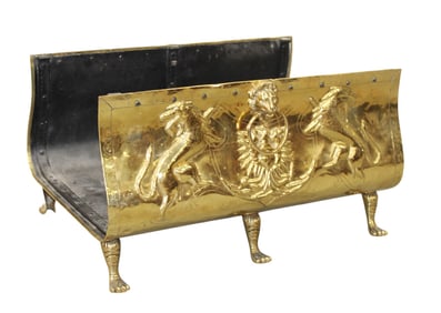 Embossed brass log holder with focal lion masks and griffins on paw feet
