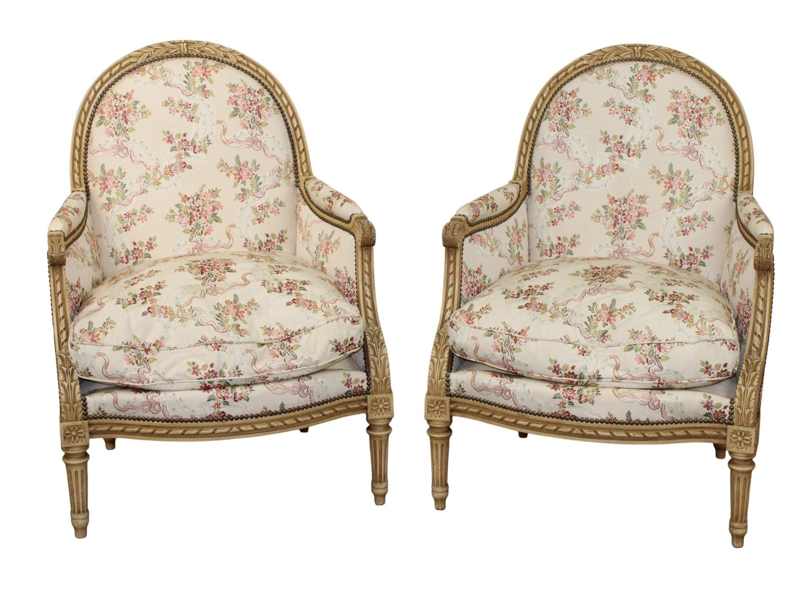 Pair of French Louis XVI style curved back bergeres: Pair of French Louis XVI style curved back bergeres. Painted finish. Fluted tapered legs. Floral upholstery. Early 20th century. 39 1/4"h x 28 3/4"w x 22 1/2"d Seat 18"h