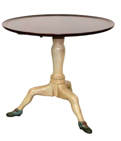 Whimsical tilt top table in mahogany on triped base with legs