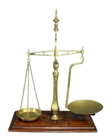 Brass pharmacy scale on wooden base with weights and brass pans