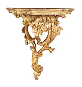 Cast wall shelf in gold finish with acanthus scrolls