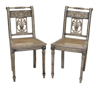 Pair of French Louis XVI style side chairs with relief carved and painted back and cane seat