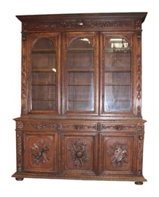 French 3 door bookcase in oak with relief carved panels with attributes of the arts and sciences