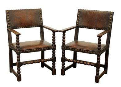 Pair of French studded leather arm chairs