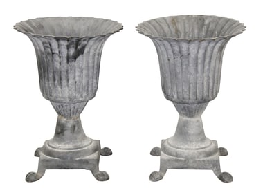 Pair of neoclassical style flared and fluted cast iron footed garden urns