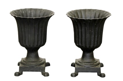 Pair of neoclassical style flared and fluted cast iron footed garden urns