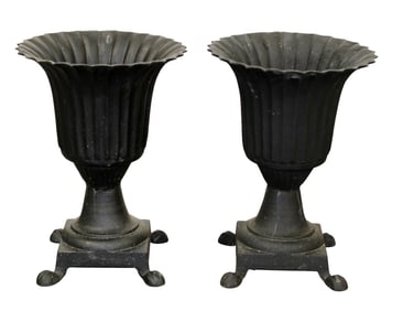 Pair of neoclassical style flared and fluted cast iron footed garden urns