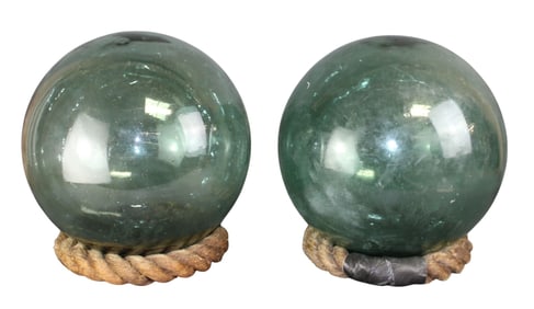 Pair of blown glass buoys on rope bases