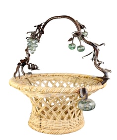 Large wicker basket with iron handle and blown glass fruit