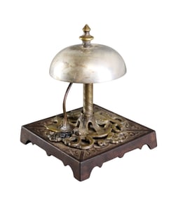 Bronze hotel or butler's bell on cast iron base