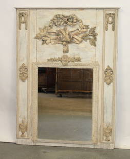 French 18th century trumeau mirror: French 18th century trumeau mirror with raised carved wooden ribbon and bow above attributes of the arts with laurel leaves. 59 1/8"h x 44 1/2"w