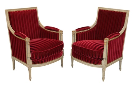 Pair of French Louis XVI bergères with painted finish and red striped upholstery
