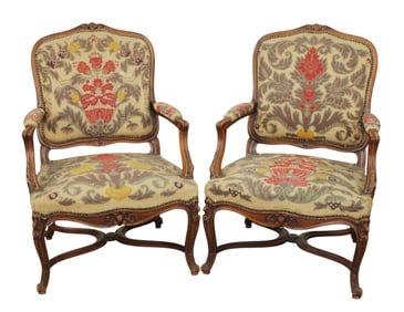 Pair of French Louis XV style armchairs in carved walnut with needlepoint upholstery