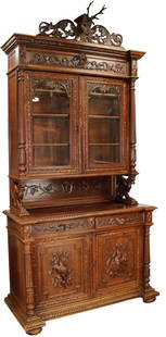 French hunt buffet in oak with relief carved game: French hunt buffet in oak with relief carved game on lower doors and deer head crest. Late 19th century. 112"h x 56 1/2"w x 25 1/2"d