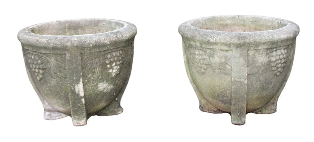 Pair of cast garden stone urns with grapes in relief