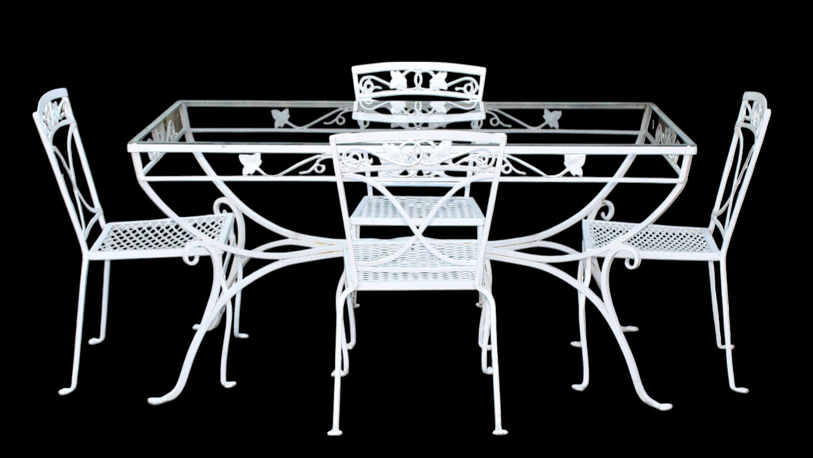 Woodard painted cast iron and glass garden table and chairs: Woodard painted cast iron and glass garden table and chairs. Table measures 29 5/8"h x 60 3/8"w x 32 1/4"d, chairs measure 33 1/8"h x 17 7/8"w x 19 3/4"d, seat height 16 3/8"h
