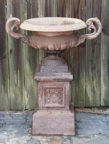 Single classical cast iron urn on pedestal