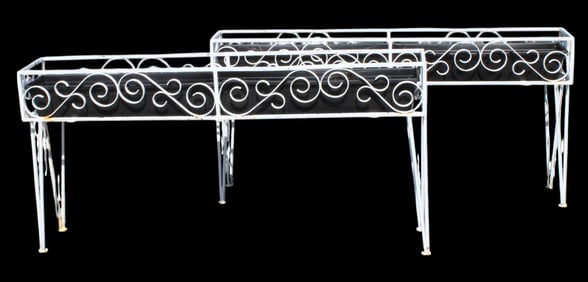 Pair of scrolled white painted iron jardiniere planter boxes on legs