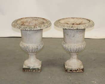 Pair of white painted iron fluted urns