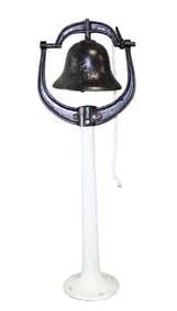 Cast iron bell on porcelain over iron stand